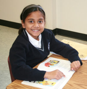 Photo of TCMPS Private Elementary School student reading a book